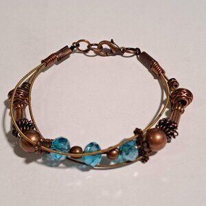 copper color bracelet with blue beads